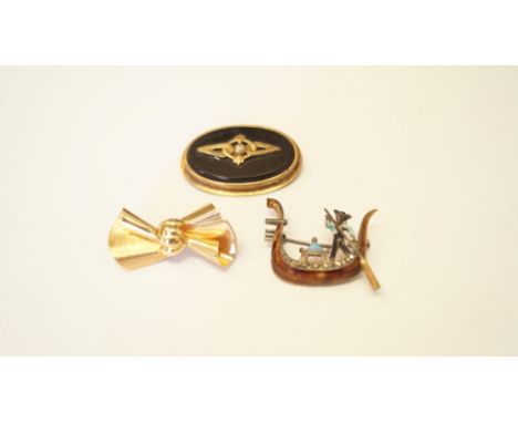 A 9ct yellow gold bow brooch; together with 935 silver and enamel 'Gondolier' brooch; and one other