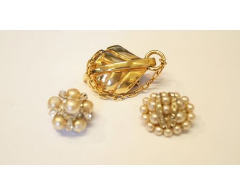 Christian Dior: a pearl and diamante cluster brooch, 1959; together with a large contemporary leaf brooch, 1971; and another 
