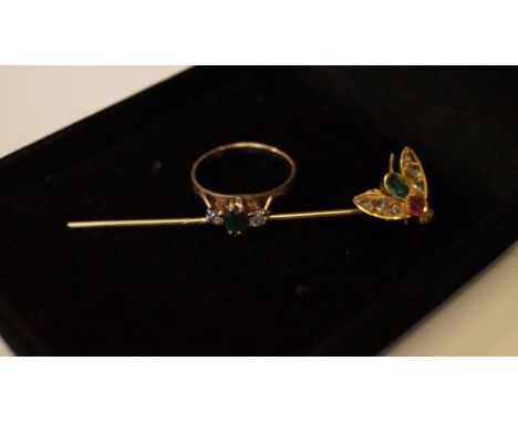 An Victorian unmarked yellow metal bee stick pin set ruby, emerald and diamonds; together with a 14ct yellow gold ring set ba