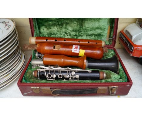 A Corton clarinet, boxed; together with another musical instrument.