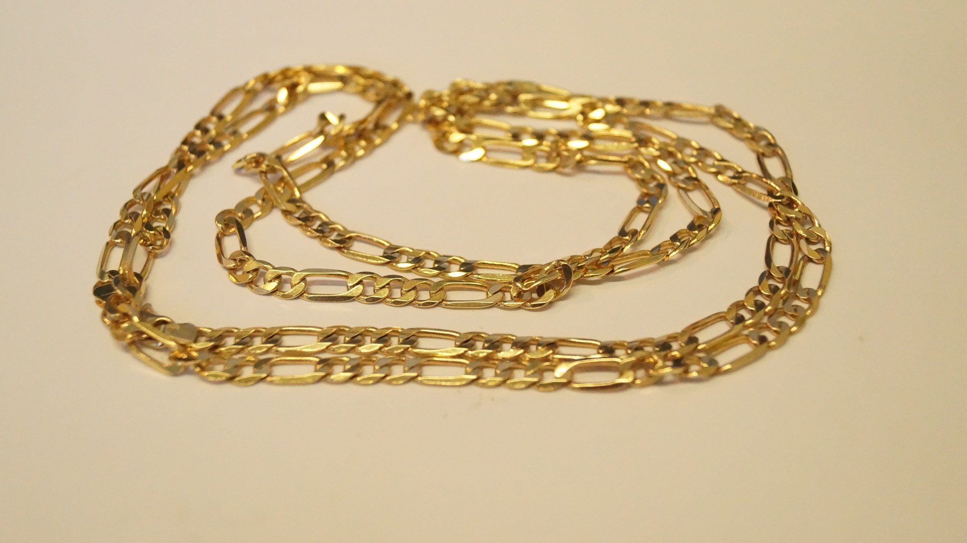 An 18ct yellow gold figaro necklace, 46g.
