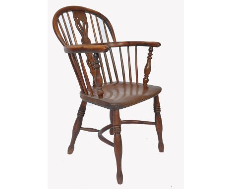 A late&nbsp; 18th / early 19th Century elm and yew wood Windsor farmhouse elbow chair. The arched stick back with a central s