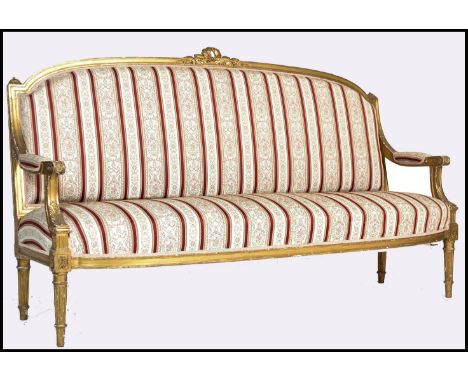 A 19th century French gilt wood canape sofa / day bed being raised on gilt reeded, turned legs with show wood gilt frame, scr