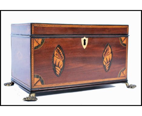 A fine 18th / 19th century George III mahogany inlaid tea caddy. Raised on brass lion hairy paw feet with conch shell and sta