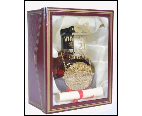 A vintage bottle of Whyte &amp; Mackay 21 yr old Scotch Whisky in presentation box with scroll.