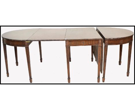 A 19th century large solid mahogany extending twelve seat dining table raised on fantastic tapering block legs with carved ac