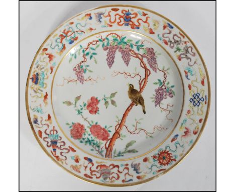 A Chinese famille verte - rose&nbsp;plate - Kangxi period (1662-1722) being finely painted with a bird perched on a branch su