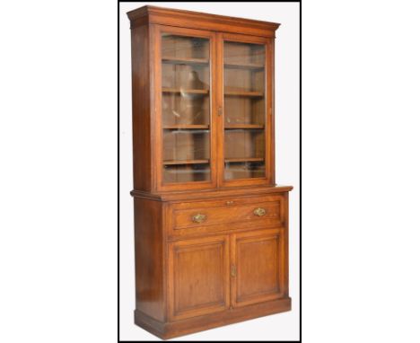 A Victorian late 19th century Maple &amp; Co ( London &amp; Paris ) golden oak secretaire bookcase. Raised on a plinth base w