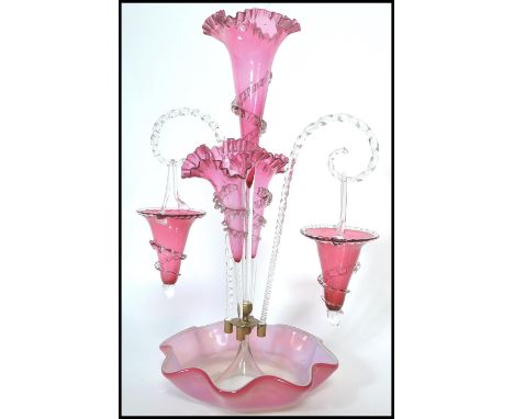 A 19th century Victorian cranberry ruby glass vaseline glass epergne centre piece, the central trumpet with frilled with trai