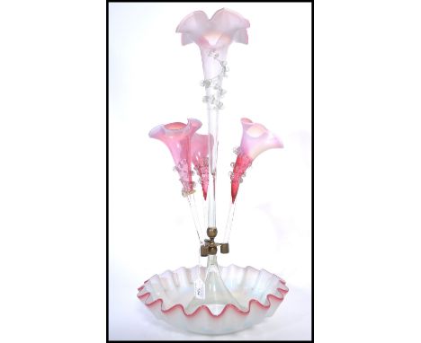 A 19th century Victorian cranberry ruby glass vaseline glass epergne centre piece, the central trumpet with frilled embellish