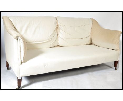 A late Victorian, circa 1900 mahogany framed and upholstered sofa by Howard &amp; Son, stamped to rear leg Howard &amp; Sons 