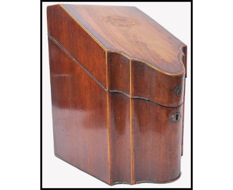 A 19th Century Georgian mahogany knife box of serpentine form, the original fitted interior intact, having inlaid floral deta