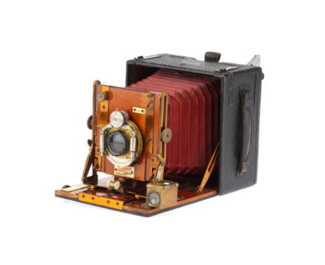 A Sanderson 5 x 4in Hand and Stand Camera made by George Houghton &amp; Sons, circa 1903, black with red bellows, retailer's 