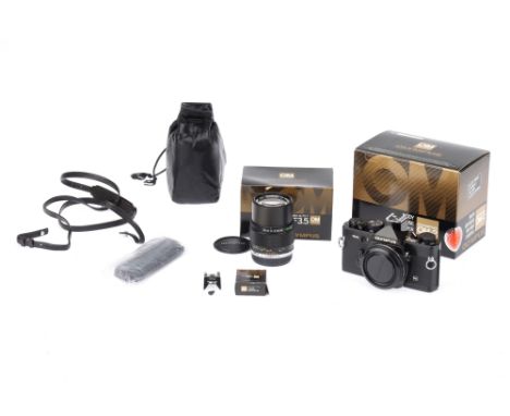 An Olympus OM-2n SLR Body black, serial no. 957018, body VG, shutter untested, with Shoe 2, Shoe 4, instruction manual, origi