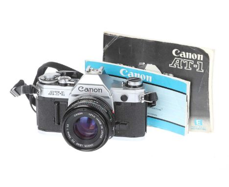 A Canon AT-1 35mm SLR Camera, chrome, body G, shutter working when batteries are inserted, together with a Canon FD f/1.8 50m