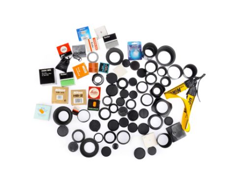 A Collection of Camera Lens Accessories including lens hoods, front and rear lens caps, body caps, mount adapters and filters