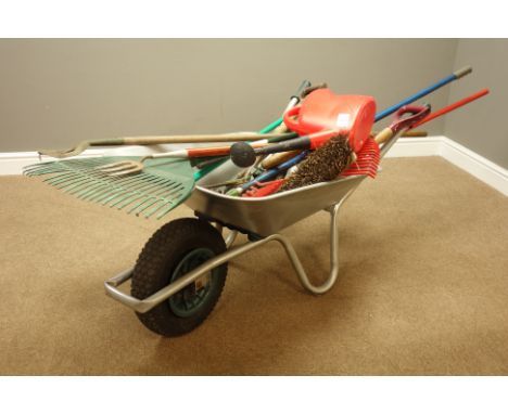 Various garden tools including forks, rakes, spade, etc... and a metal wheelbarrow    Condition Report   Click here for furth