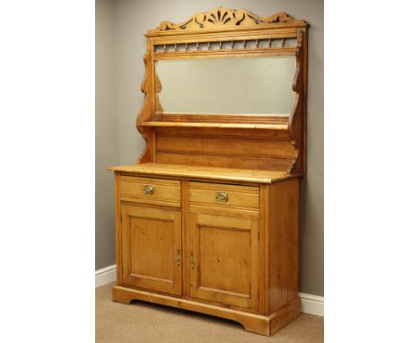 Late Victorian pine mirror back side cabinet, shaped pierced pediment above shelf, two drawers and panelled cupboards, plinth