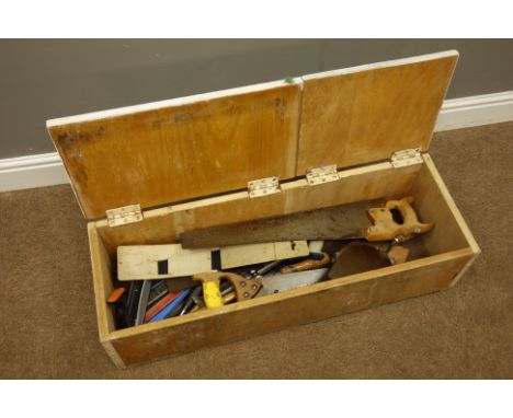 Various tools in wooden tool box including - variety of hand saws, hand drill, hammers etc...