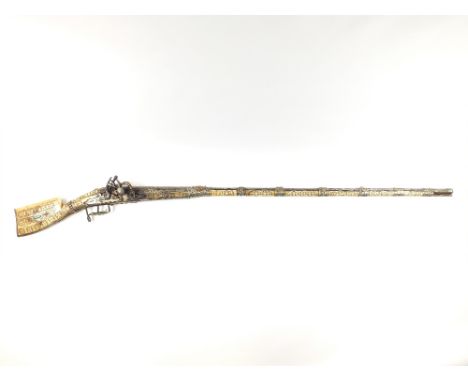 An Afghan Snaphaunce Musket, 48.25inch sighted two-stage barrel retained by seven embossed white metal barrel bands decorated