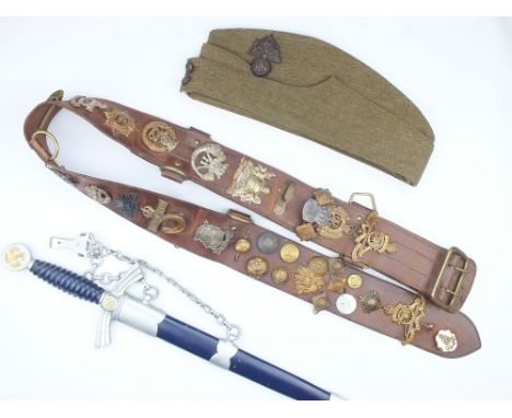 A Sam Browne Belt Applied with Cap Badges, comprising Royal Artillery, Royal Engineers, ARP lapel badge, six rank pips, one e