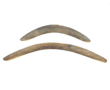 Two Stone Carved Boomerangs, the first 74cm in diameter and decorated with two Kangaroo and four Emu, together with another s