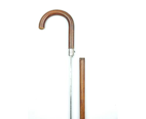 A Victorian Silver Mounted Swordstick, 70cm fullered blade decorated with scrolling foliage and TOLEDO, bent can handle with 