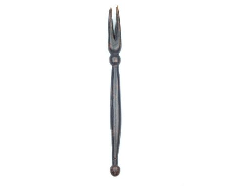 A Fijian Cannibal Fork, 27.5cm over all length, the slightly swollen haft with spherical terminals, the head with four taperi