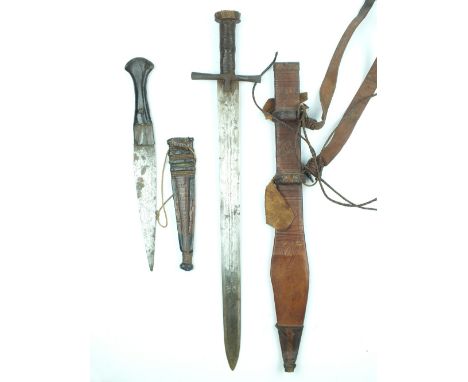 A Sudanese Kaskara, 48cm double fullered blade struck with double crescent moon marks to either side, contained in its tooled