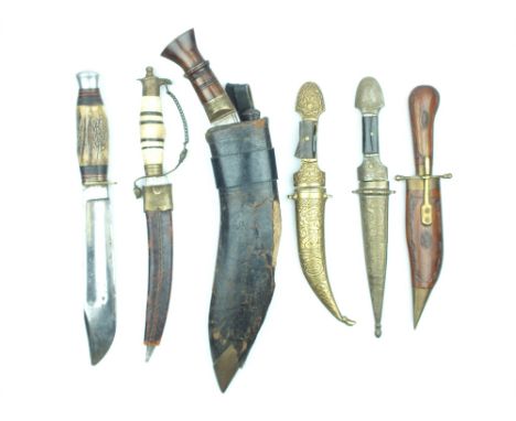 A Small Collection of Daggers and Knives, comprising a Kukri, an eagle pommelled dagger, two brass mounted Jambiya and an Ind