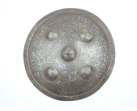 An Indo-Persian Damascene Shield, the 35.5cm diameter steel shield decorated over all in silver damascene with stylised calli