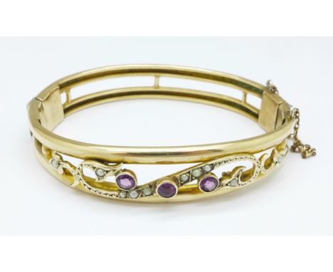A Victorian amethyst and seed pearl bangle