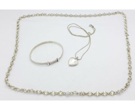 A silver bangle, neck chain and a locket with chain, 49g