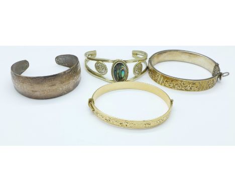 A 9ct gold on silver bangle and three other bangles