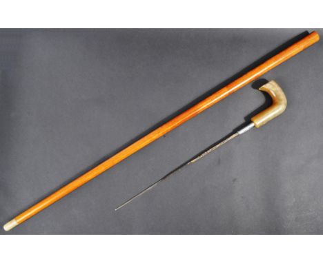 A 20th Century gentleman's sword stick / walking cane with concealed blade. The cane having a curved Rhino horn grip and tape
