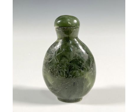 A Chinese hardstone snuff bottle, possibly spinach green jade. Engraved with a small scene depicted as a bird flying to a tre