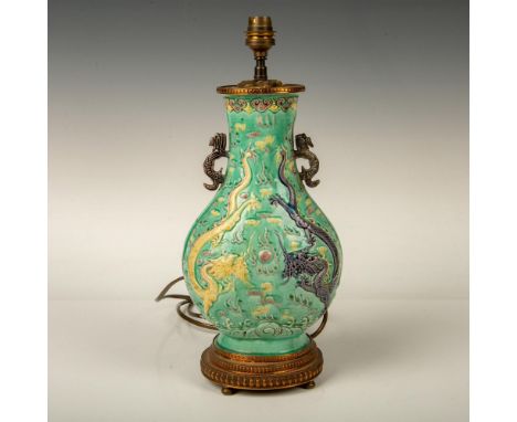 A beautiful glazed lamp featuring two dragons fighting over a pearl. Molded ceramic Shenlong dragons as the handles. Green, p