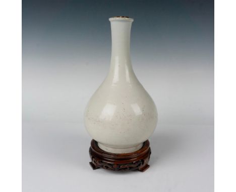 A Blanc de Chine bottle formed vase with beautiful faint incised flowers around the body. This item has a base included: 5.5"