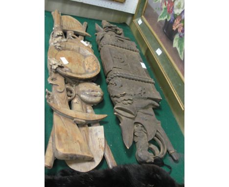 Two finely carved overdoor panels depicting gold prospectors' tools and hunters' items, possibly Black Forest