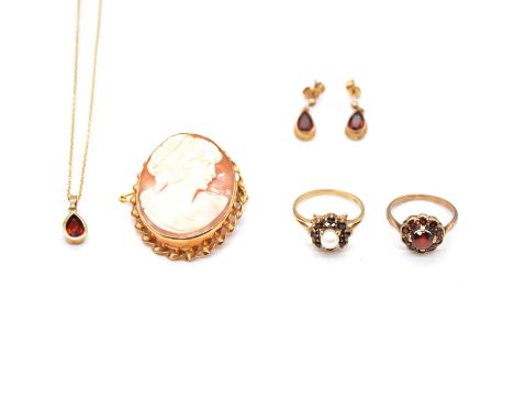 A cameo brooch, suite of garnet jewellery and two rings, an oval carved shell cameo 35x25mm, set in a 9 carat yellow gold mou