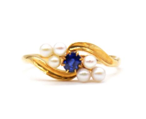 A sapphire and pearl ring, a central round faceted sapphire with three 3mm cultured pearls to each side in an all yellow meta