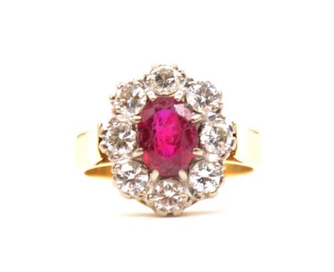 CATALOGUE AMENDMENT A ruby (synthetic ruby) and diamond cluster ring, the oval mixed cut ruby, 8.3x6.2mm, claw set and surrou