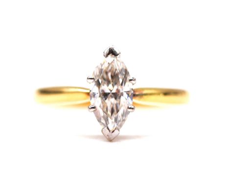 .A diamond solitaire ring, the marquise cut stone claw set in an 18 carat yellow and white gold mount ring size M, approximat