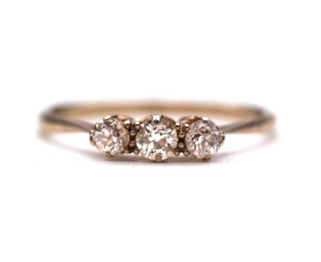 A diamond three stone ring, the three old cut stones claw set in an all white metal mount ring size V, shank marked 18ct, gro