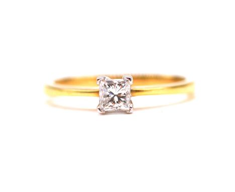 A diamond solitaire ring, the princess cut stone claw set in an 18 carat yellow and white gold mount ring size L, valuation f