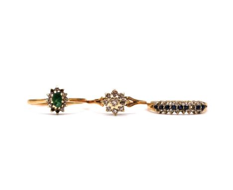 Three 9 carat gold gemset rings, a small illusion set diamond cluster ring; an oval cluster missing four small diamonds, gree