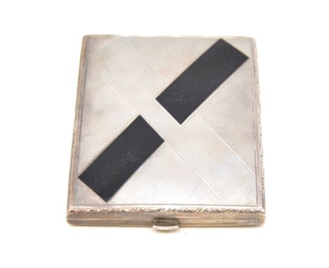 A silver coloured cigarette case, engine turned design with large Art Deco design cross motif having black enamel decoration 