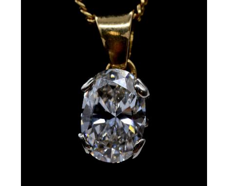 A diamond solitaire pendant, the oval brilliant cut diamond four claw set in unmarked yellow and white metal, on a flat curb 