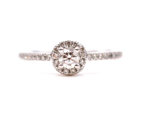 A diamond halo circular cluster ring, a central 3.7mm brilliant cut diamond four claw set and surrounded by fourteen smaller 