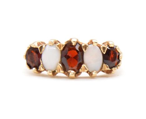 A garnet and opal half hoop ring, the three garnets and two opals claw set in a 9 carat yellow gold mount size N1/2, Birmingh